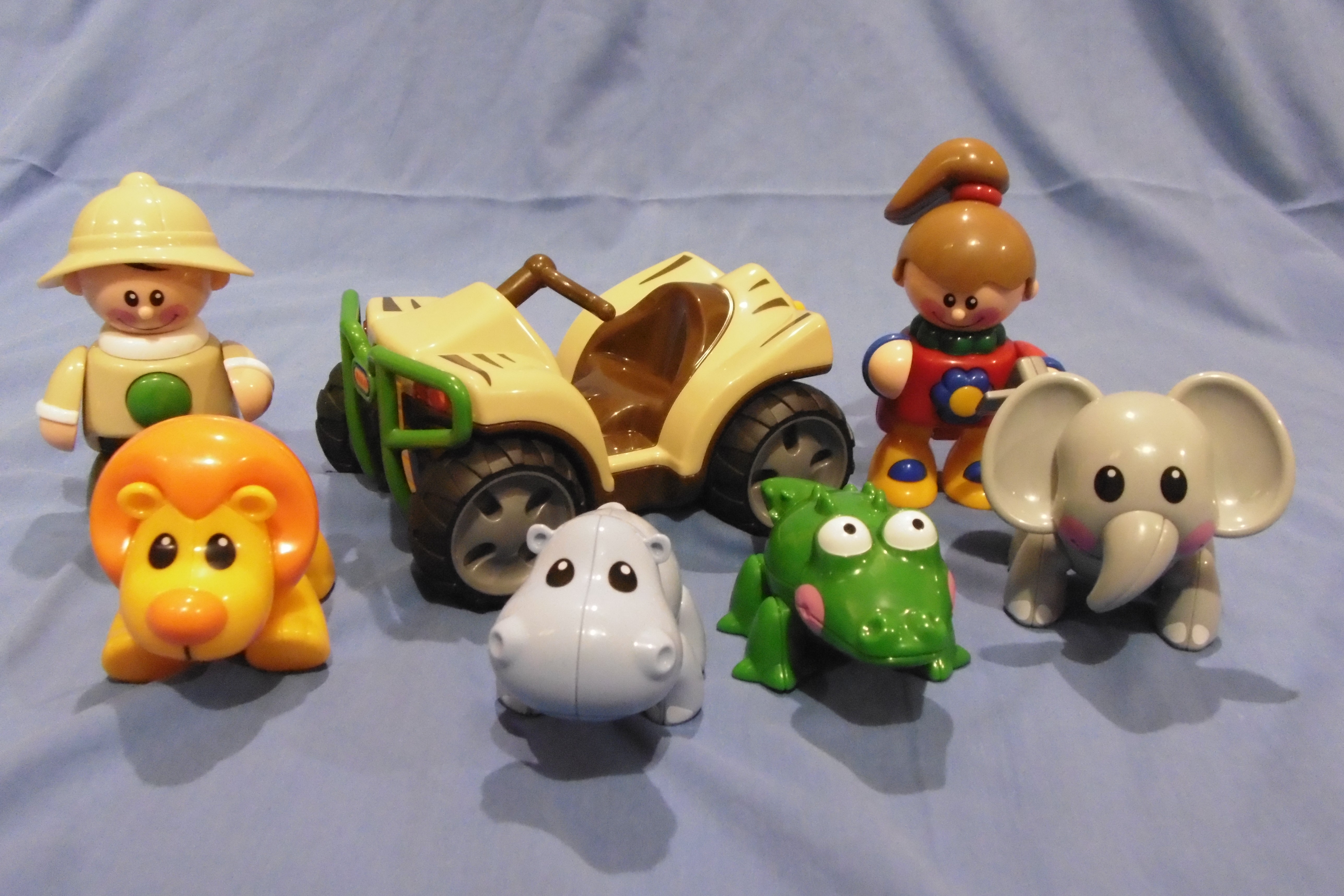 A collection of small plastic animal and people toys